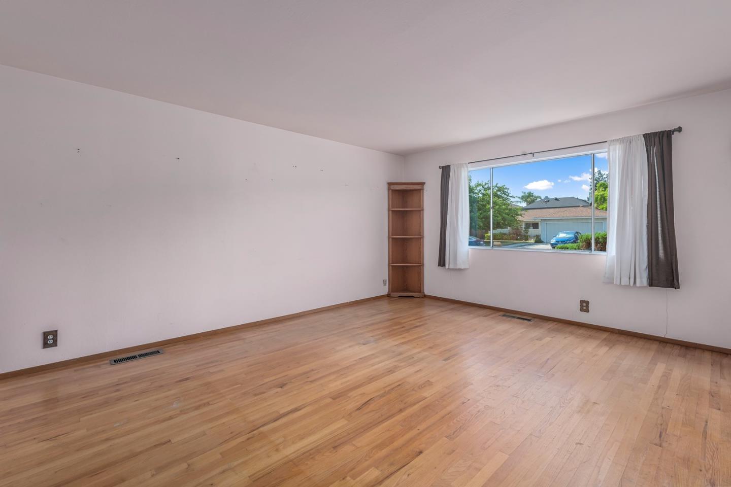 1651 Salisbury Drive San Jose, CA 95124 - Photo 3 of 22 a view of an empty room with wooden floor and a window