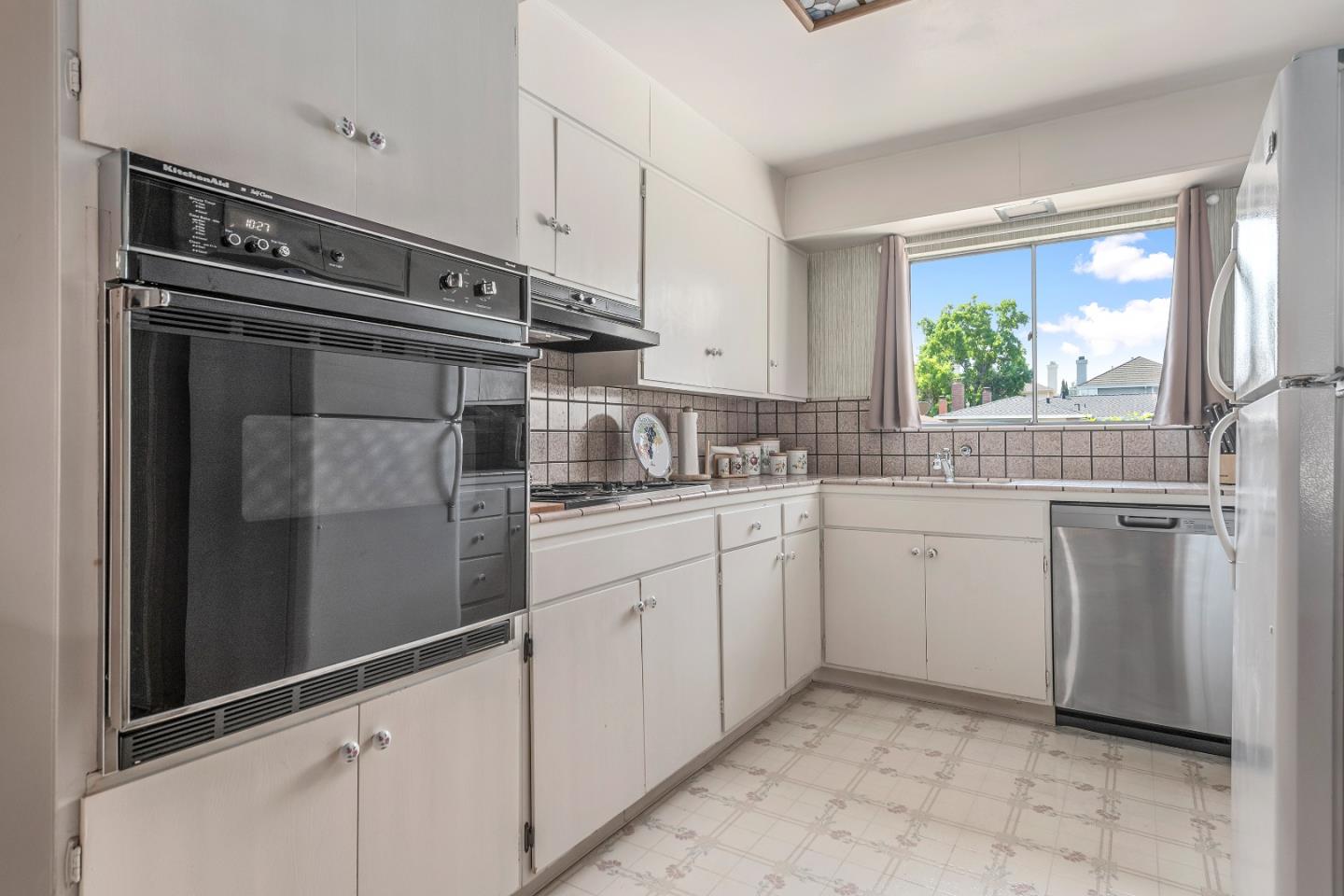 1651 Salisbury Drive San Jose, CA 95124 - Photo 6 of 22 a kitchen with white cabinets and white appliances