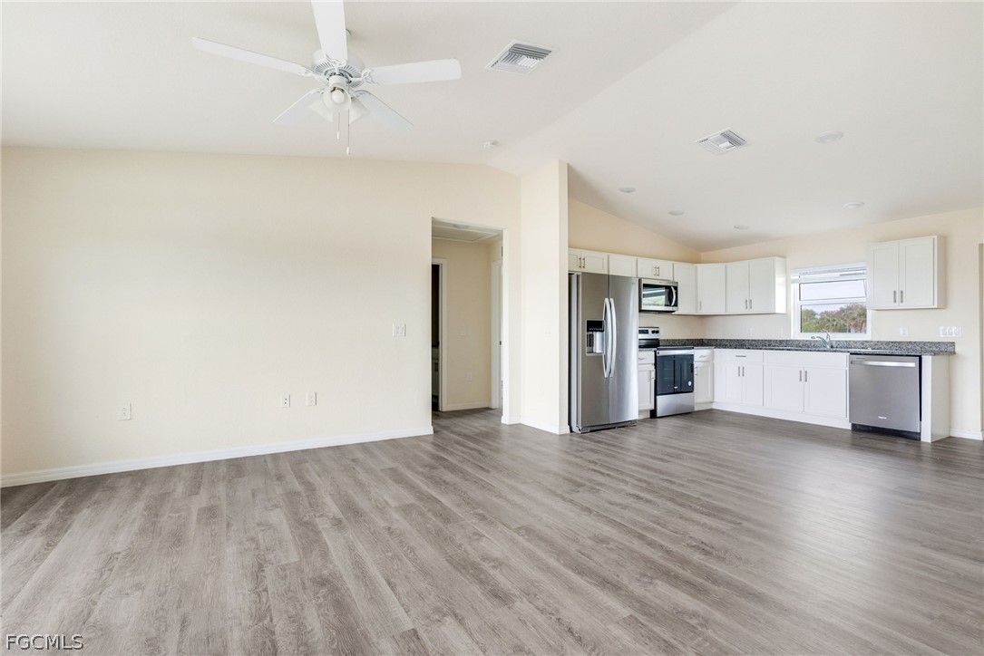 1405 Inwood Road LaBelle, FL 33935 - Photo 3 of 35 a view of a kitchen with wooden floor and a kitchen