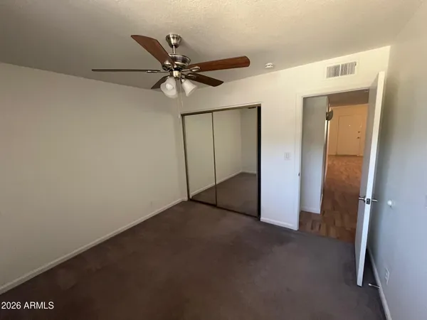 a view of walk in closet with wooden floor