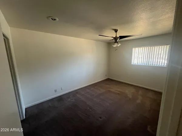 a living room with couches and a dining table with a potted plant