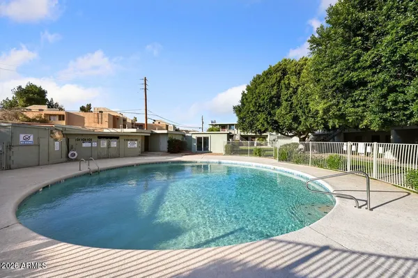 a view of a patio with a dining table and chairs with wooden floor