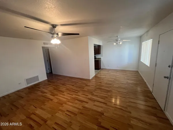 wooden floor in an empty room with a window