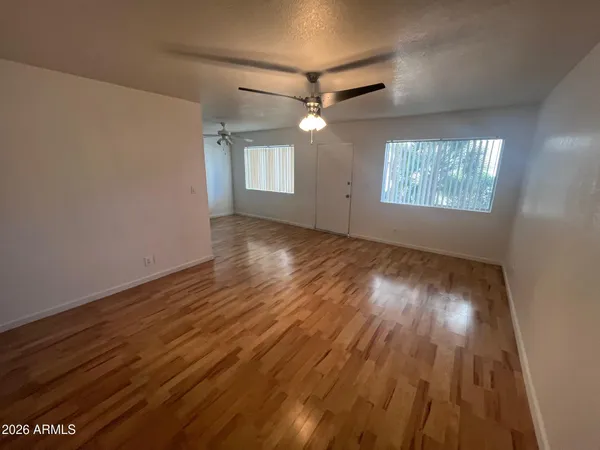a bathroom with a granite countertop sink a mirror and a toilet