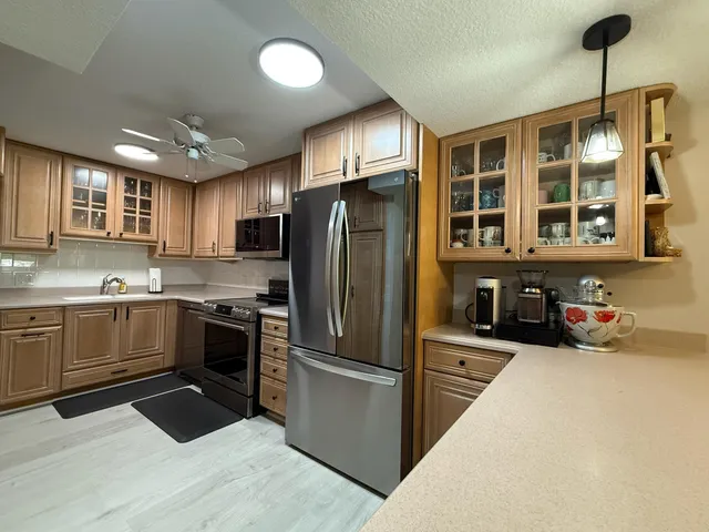 a living room with furniture a chandelier and a dining table