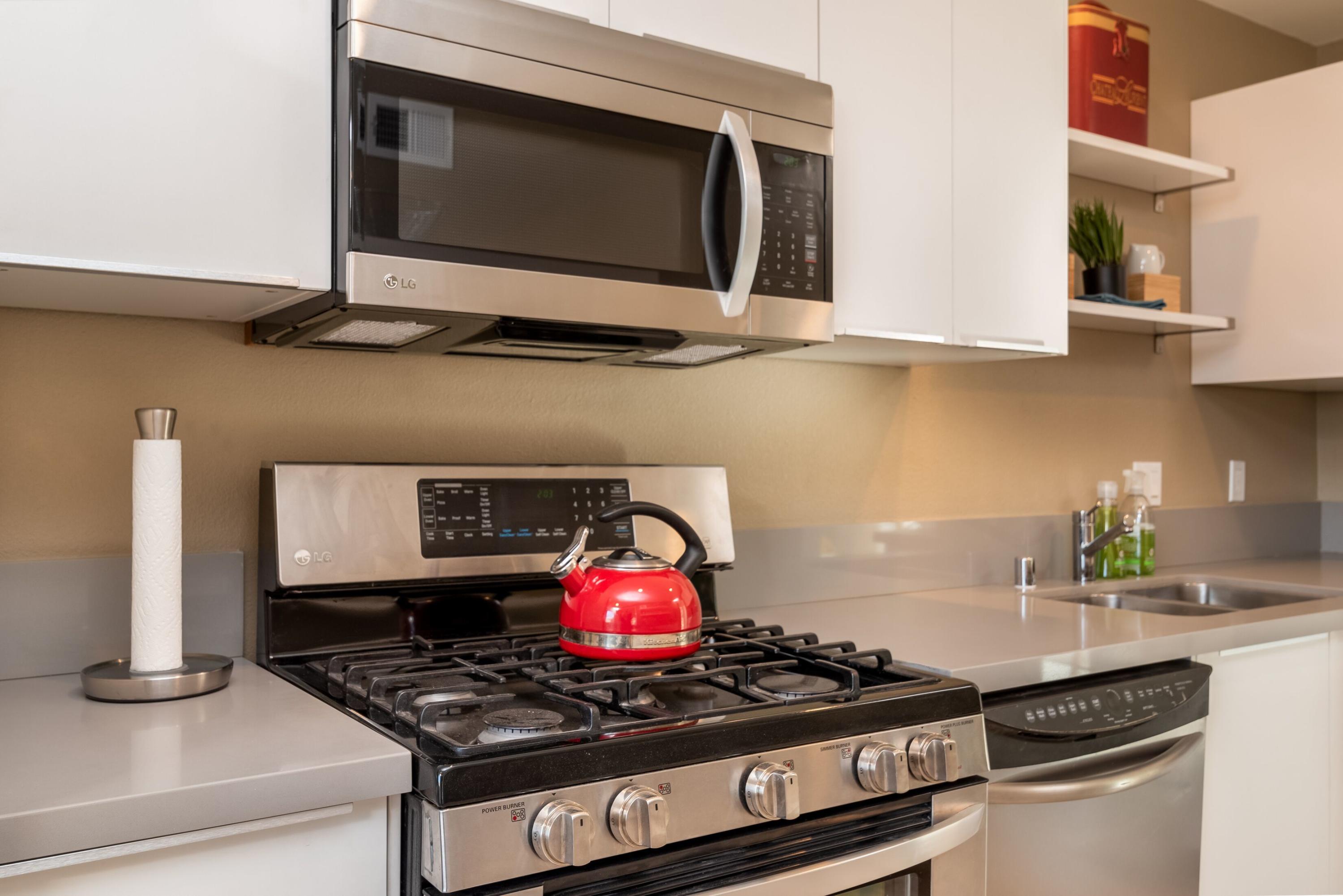 68195 Terrace Road Cathedral City, CA 92234 - Photo 11 of 33 a kitchen with stainless steel appliances granite countertop a stove and a microwave