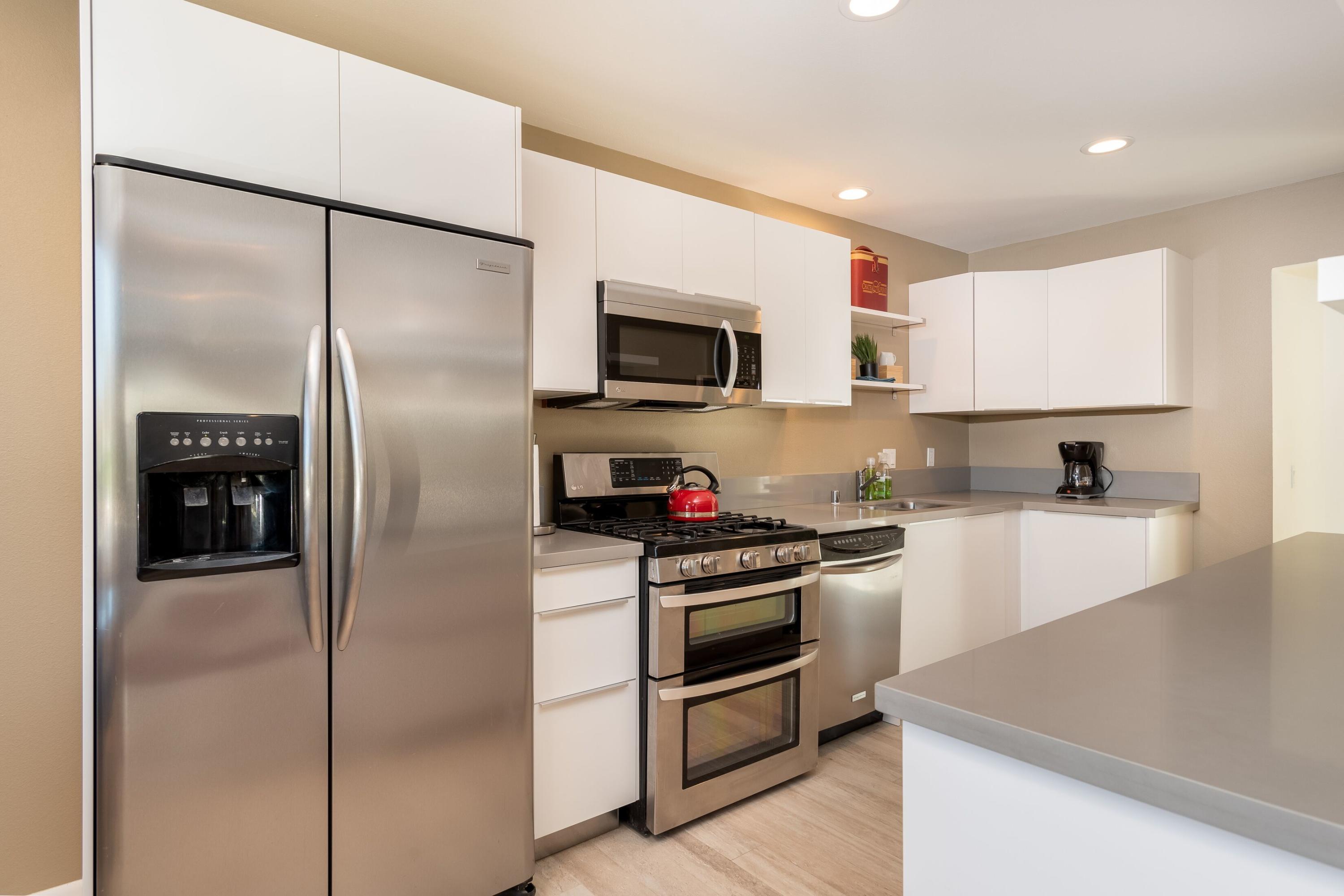 68195 Terrace Road Cathedral City, CA 92234 - Photo 10 of 33 a kitchen with a refrigerator and a stove top oven