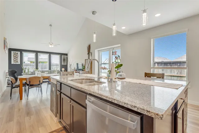 a kitchen with center island table and chairs