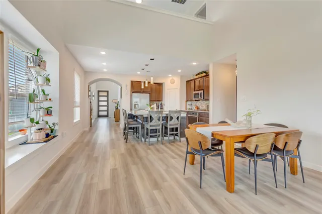 a view of a dining room with furniture and wooden floor