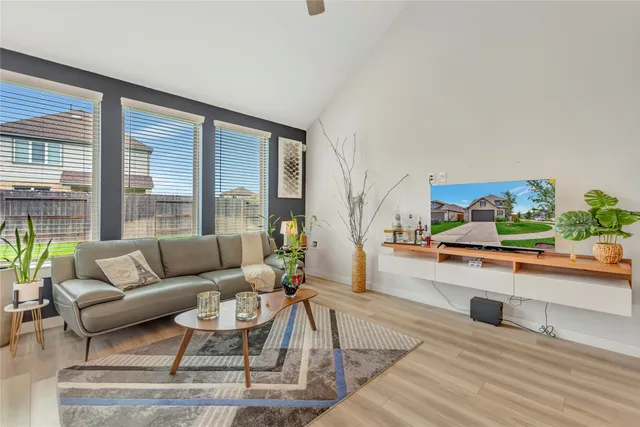 a living room with furniture and a large window