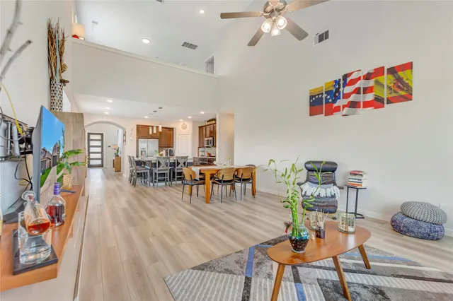 a living room with furniture and wooden floor