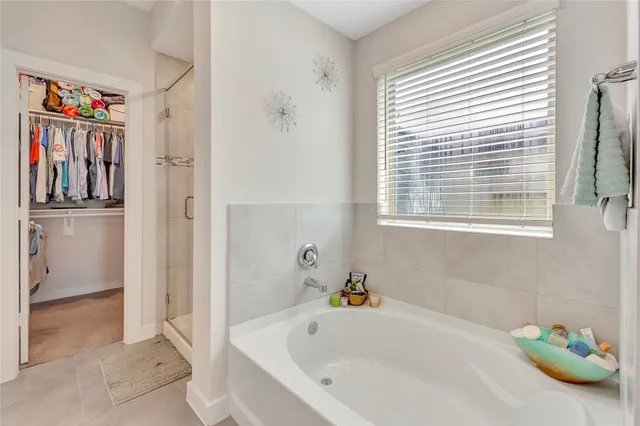 a bathroom with a tub and a shower