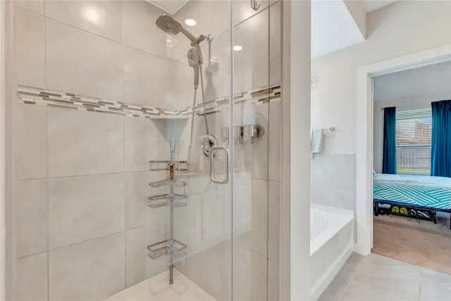 a bathroom with a shower and a tub