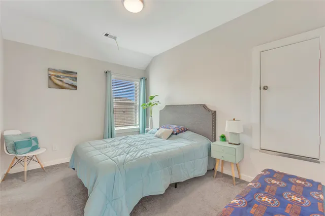 a bedroom with a bed and a dresser