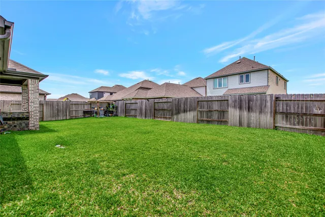 a view of a house with a small yard and sitting area