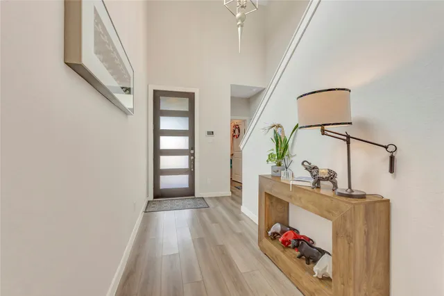 a view of hallway with wooden floor and stairs