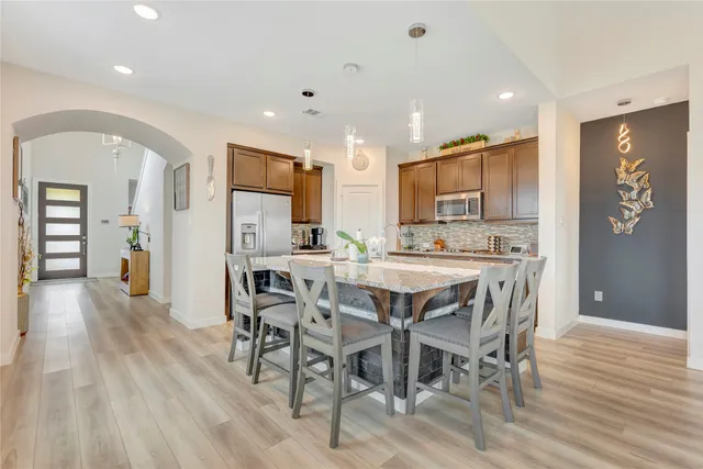 a view of a dining room with furniture and wooden floor
