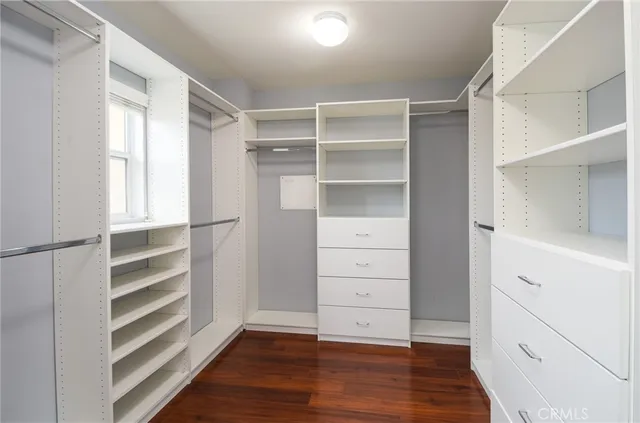 a view of walk in closet with empty racks