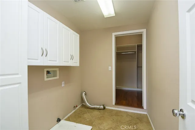 a bathroom with a granite countertop sink and cabinets