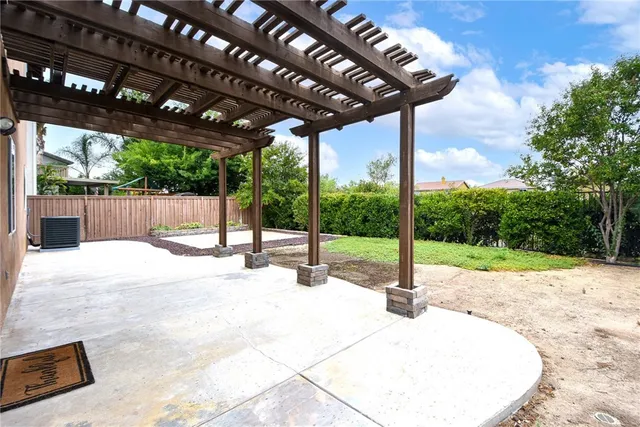 a view of a backyard with wooden fence