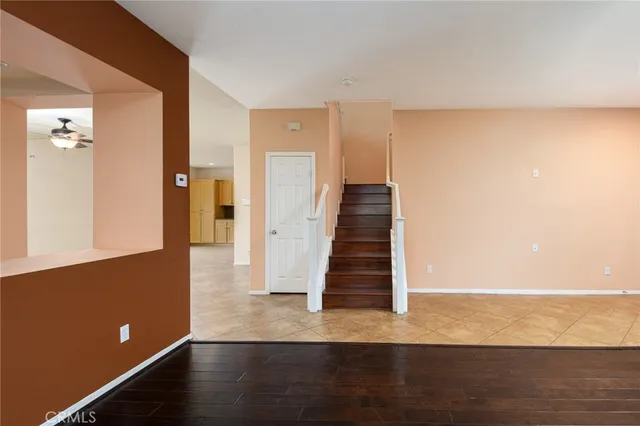 a view of a livingroom with wooden floor and stairs