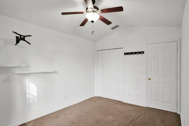 a view of a room with a ceiling fan