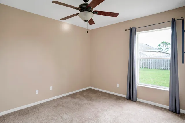 a view of an empty room and a window