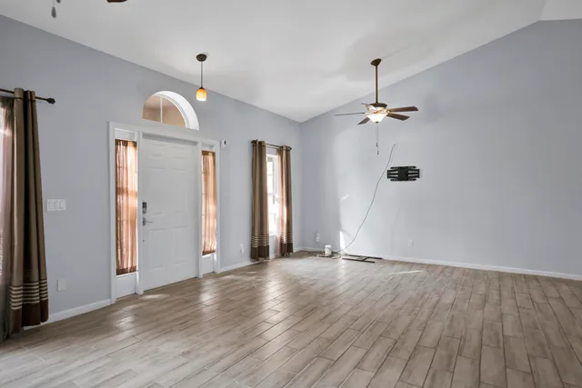 wooden floor in an empty room with a window