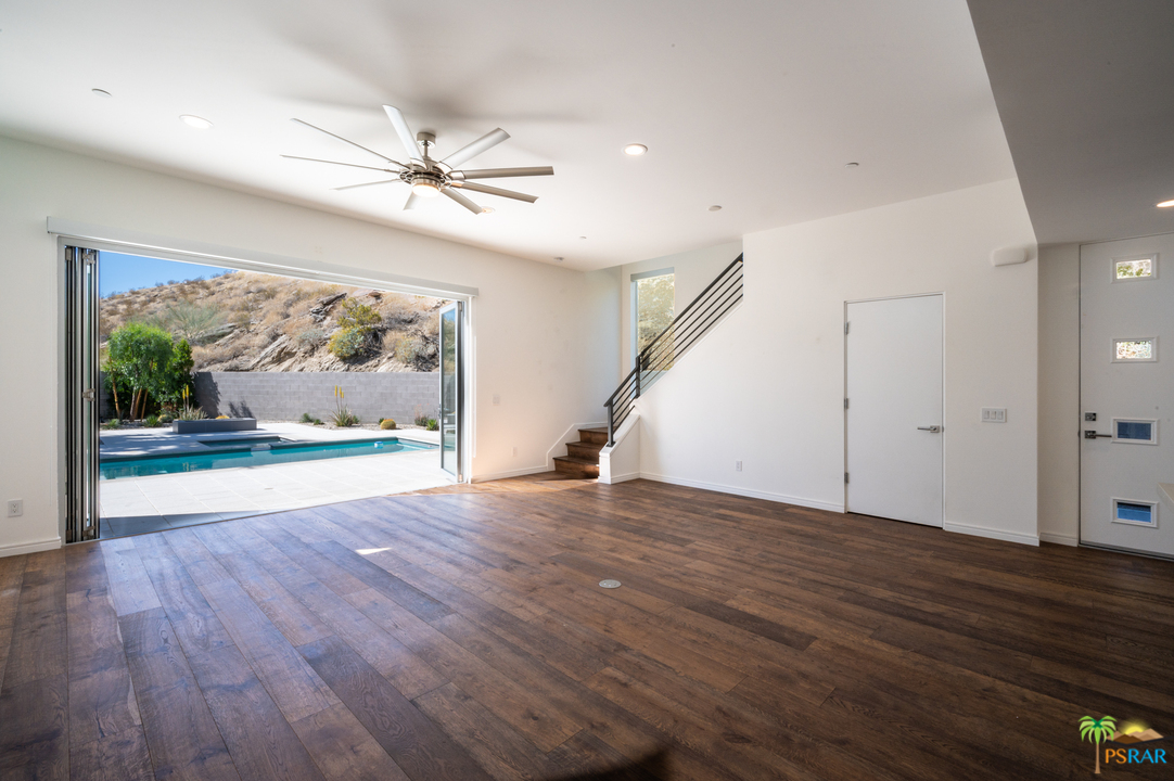 1521 South Belardo Road Palm Springs, CA 92264 - Photo 14 of 37 a view of empty room with wooden floor and fan