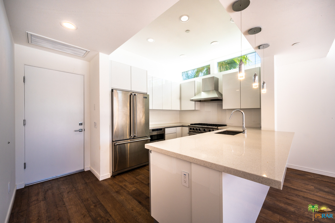 1521 South Belardo Road Palm Springs, CA 92264 - Photo 19 of 37 a kitchen with a refrigerator and a sink