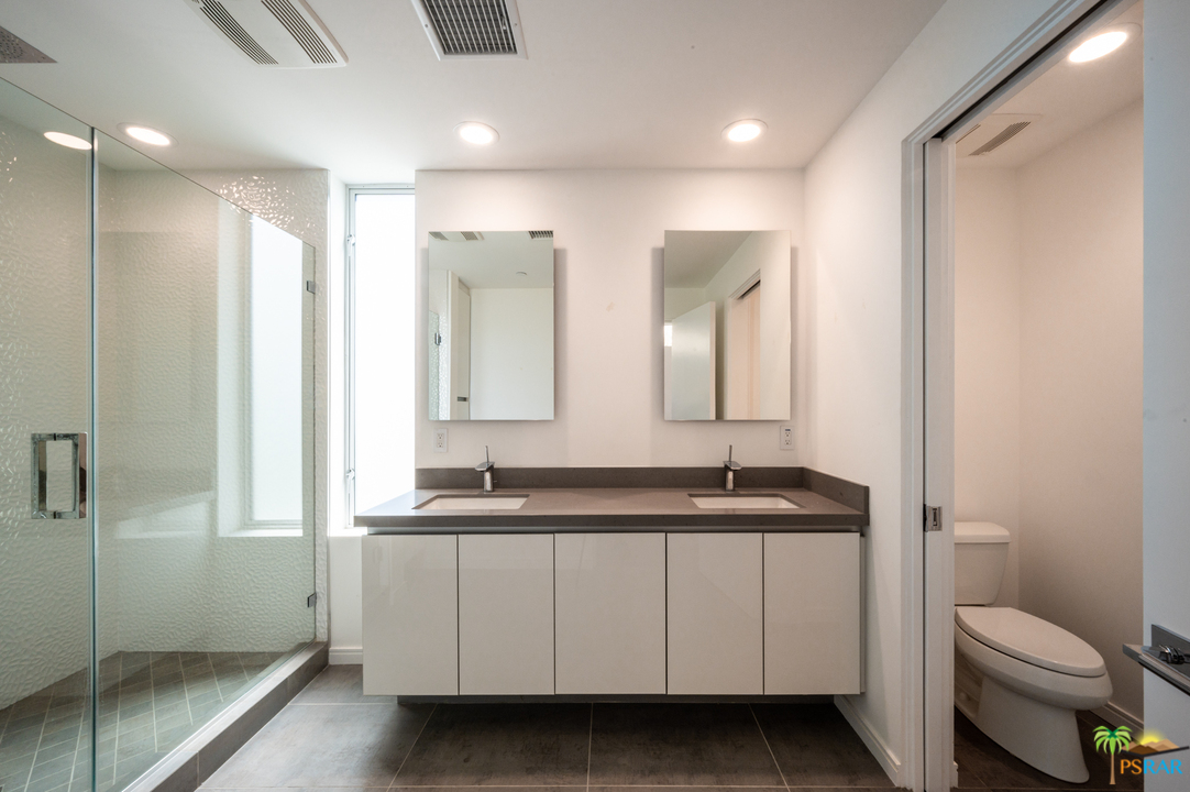 1521 South Belardo Road Palm Springs, CA 92264 - Photo 26 of 37 a bathroom with a double vanity sink toilet and a mirror