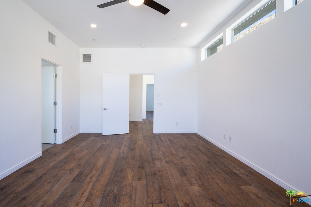 1521 South Belardo Road Palm Springs, CA 92264 - Photo 28 of 37 an empty room with wooden floor