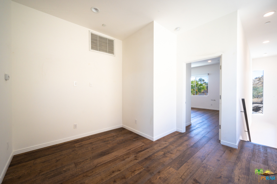 1521 South Belardo Road Palm Springs, CA 92264 - Photo 32 of 37 a view of a hallway with wooden floor
