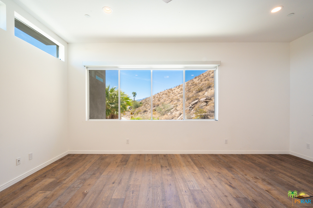 1521 South Belardo Road Palm Springs, CA 92264 - Photo 37 of 37 an empty room with wooden floor and window