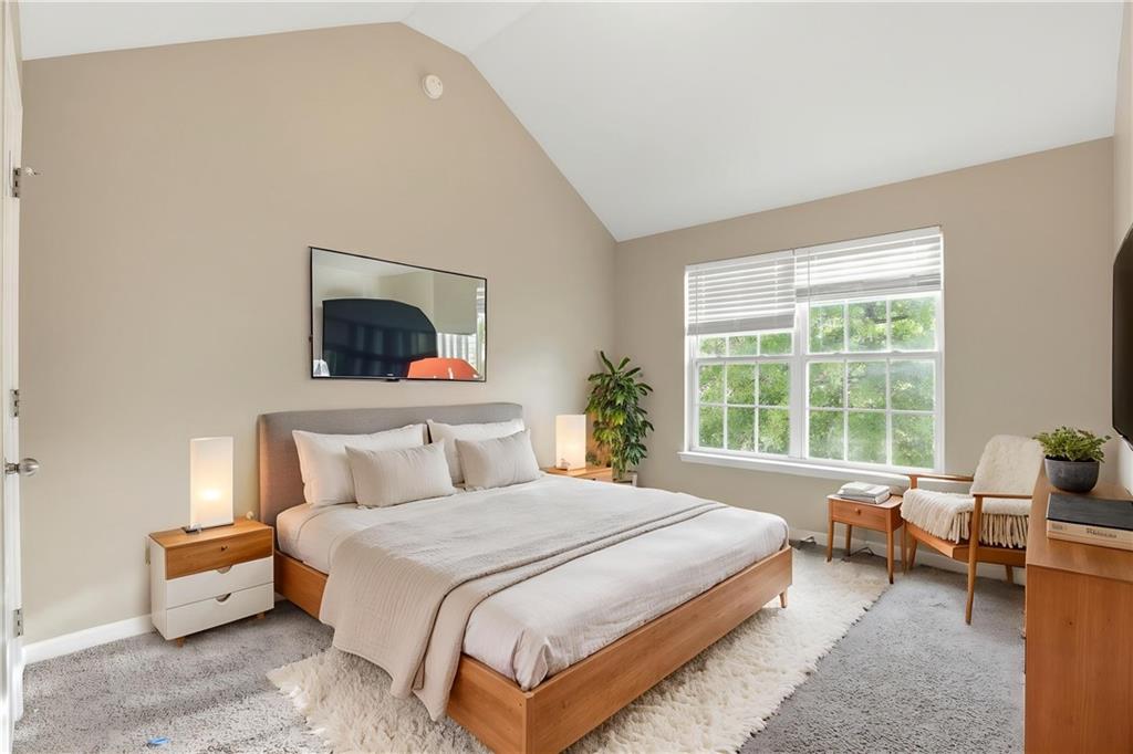 4968 Locherby Drive Fairburn, GA 30213 - Photo 6 of 39 a bedroom with a bed and glass window