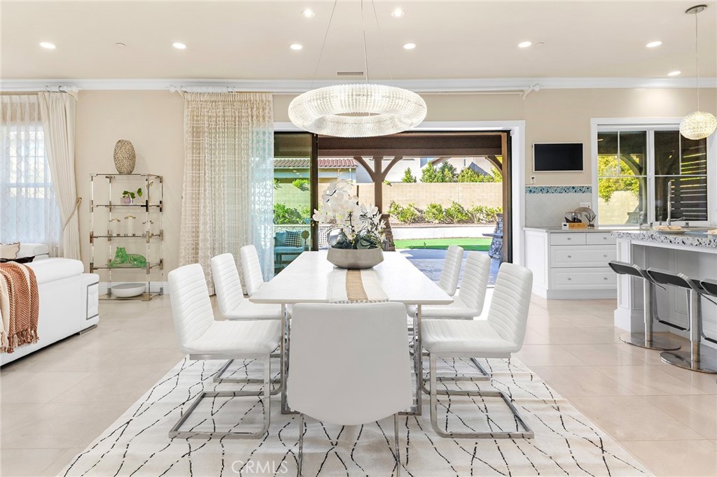 123 Calderon Irvine, CA 92618 - Photo 17 of 74 a view of a dining room with furniture wooden floor and a chandelier