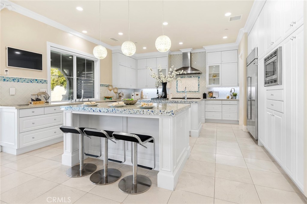 123 Calderon Irvine, CA 92618 - Photo 21 of 74 a kitchen with stainless steel appliances kitchen island granite countertop a sink and cabinets