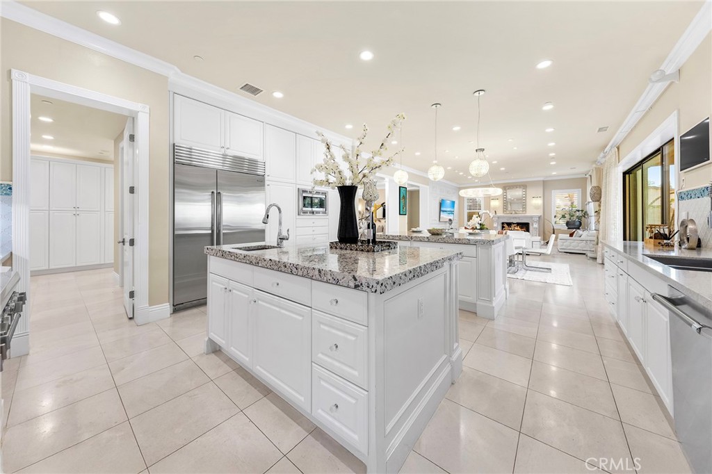 123 Calderon Irvine, CA 92618 - Photo 24 of 74 a large white kitchen with a large counter top and stainless steel appliances