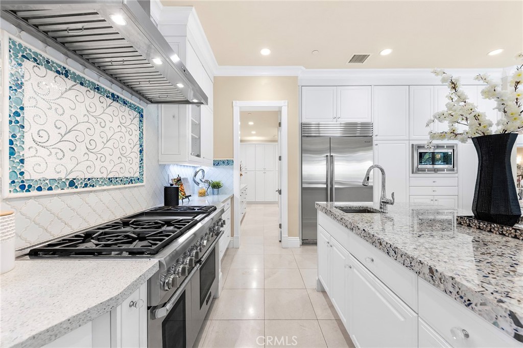 123 Calderon Irvine, CA 92618 - Photo 25 of 74 a kitchen with stainless steel appliances granite countertop a sink stove and refrigerator