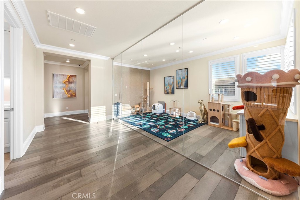 123 Calderon Irvine, CA 92618 - Photo 32 of 74 a living room with furniture a rug and gym equipment