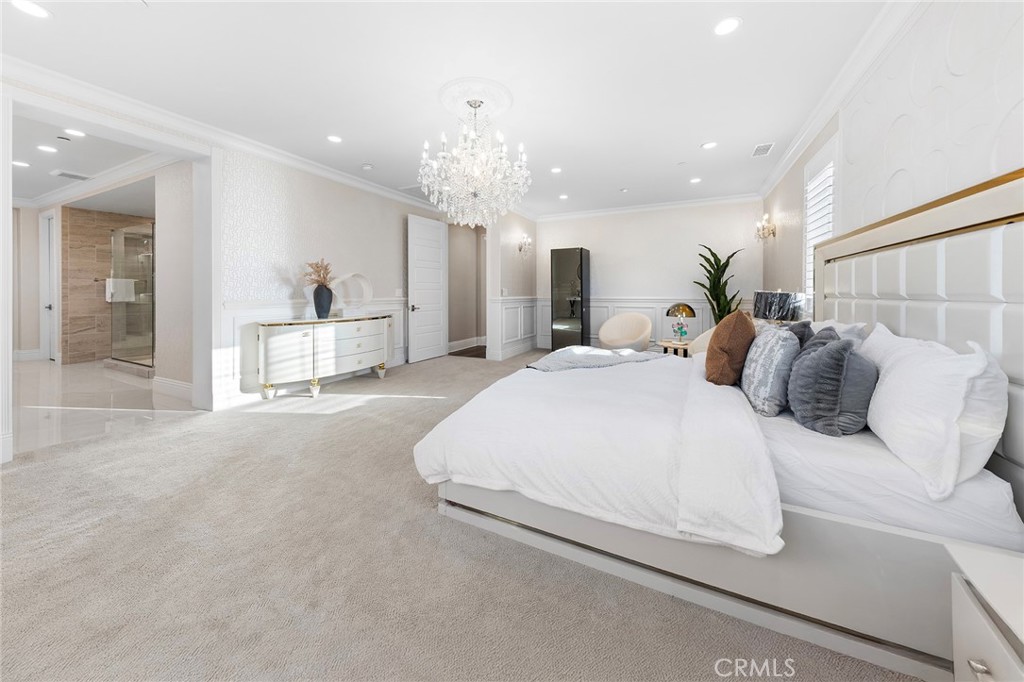 123 Calderon Irvine, CA 92618 - Photo 38 of 74 a spacious bedroom with a bed and a chandelier