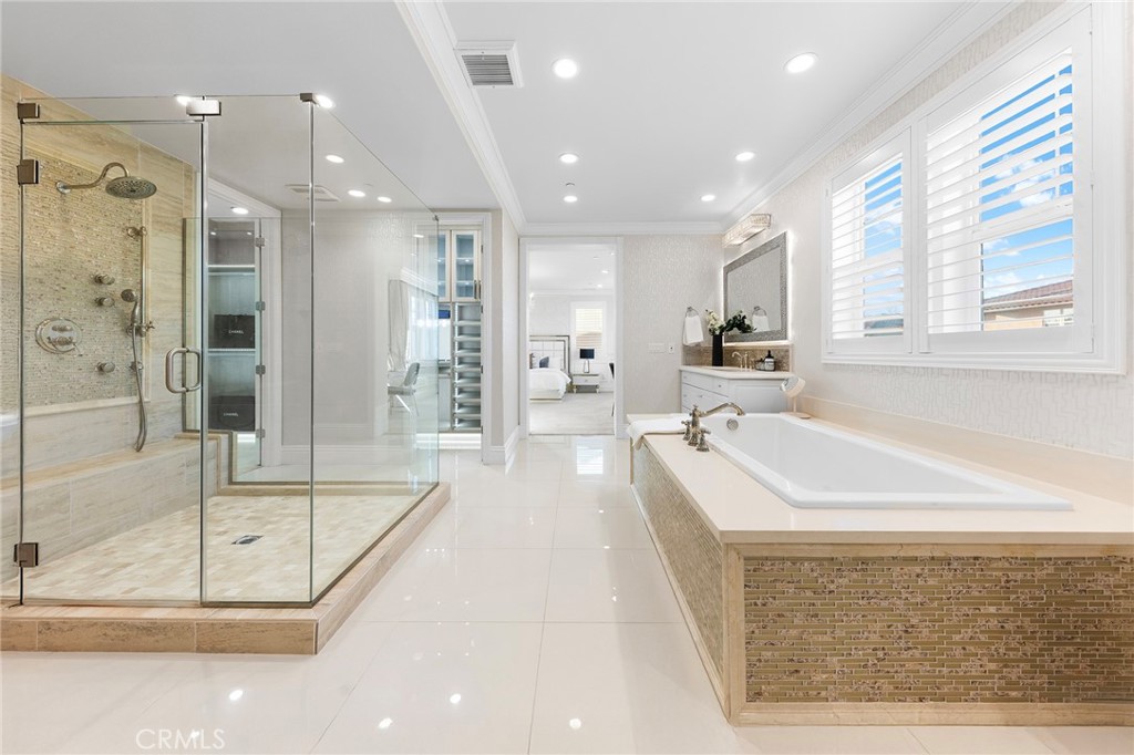 123 Calderon Irvine, CA 92618 - Photo 39 of 74 a large bathroom with a tub a shower a sink and mirror