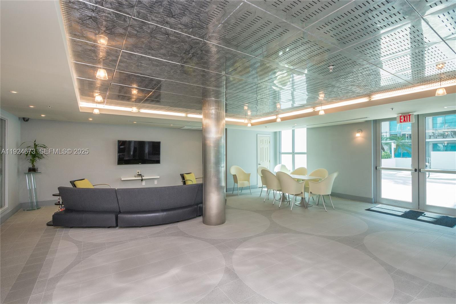 110 Washington Avenue, Unit 1822 Miami Beach, FL 33139 - Photo 14 of 17 a living room with furniture and a flat screen tv