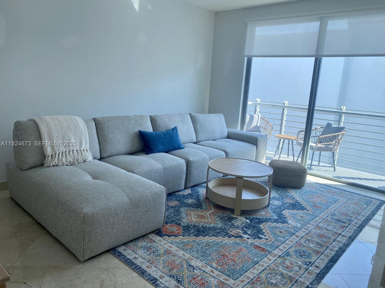110 Washington Avenue, Unit 1822 Miami Beach, FL 33139 - Photo 3 of 17 a living room with furniture and a rug
