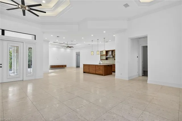 a large kitchen with kitchen island a stove a sink a counter space and a window