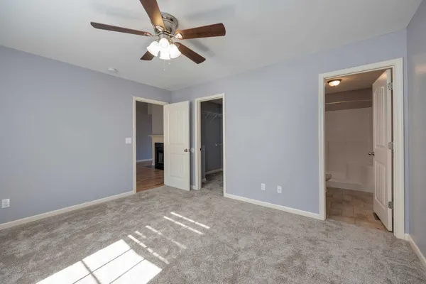 a view of empty room with ceiling fan