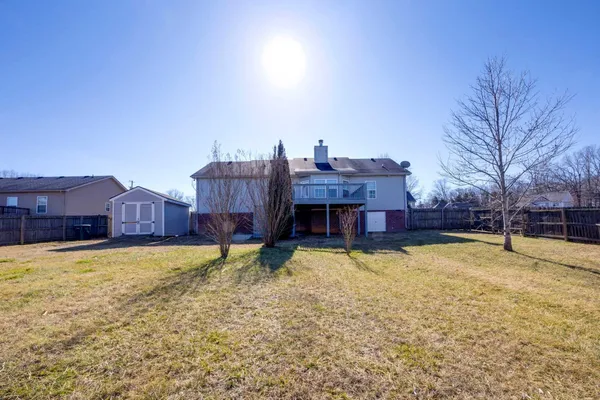 a view of a house with a yard covered with snow in front of house