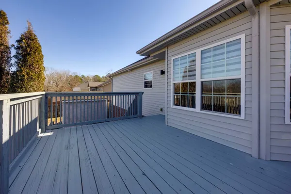a view of a house with wooden deck