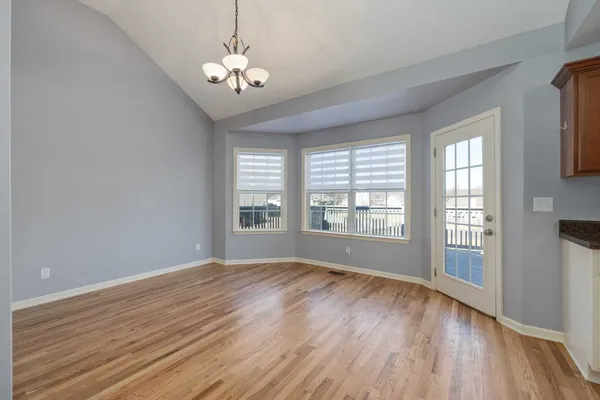 a view of a livingroom with a window and wooden floor
