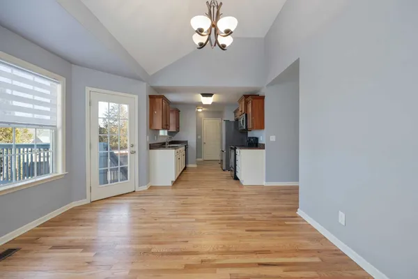 a view of a kitchen with a kitchen island wooden floor and a ceiling fan